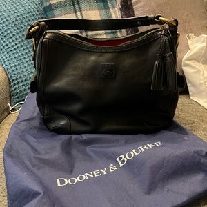 EUC Dooney And Bourke Florentine Side Pocket Hobo in black leather.